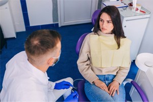 Dentist and patient discussing details of treatment