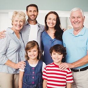 Three generations of family smiling during family dentistry