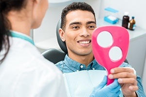 Man looking at smile after dental hygiene and teeth cleaning visit