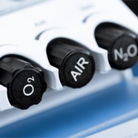 Close-up of black control dials on nitrous oxide machine