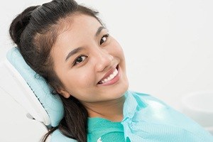 Woman smiling during all ceramic dental restoration appointment