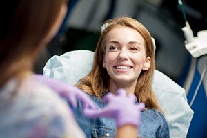 Woman sharing smile during same day dental crown treatment