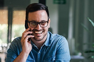 Man calling to schedule an appointment for one visit dental crown restoration