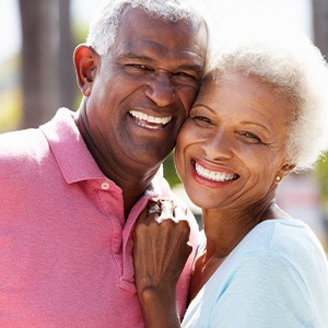 Man and woman with dentures sharing healthy smiles