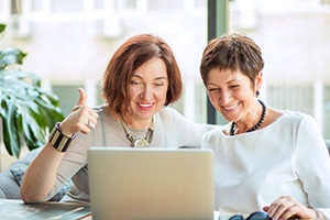 Two middle-aged women participating in video call