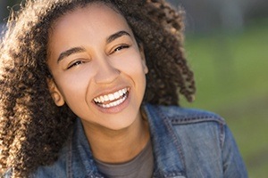 Young woman smiling after wisdom tooth extractions