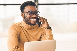 Man on phone with his emergency dentist