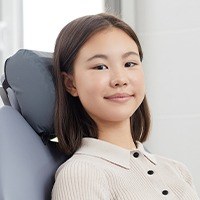 Woman smiling during emergency dentistry visit to replace knocked out tooth