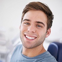 Man smiling after replacing a lost dental crown