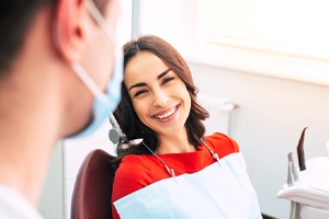 Happy woman at appointment for dental implant salvage