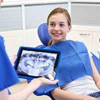 Young girl smiling during restorative dentistry services visit