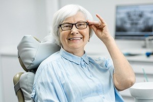 Older woman with healthy smile after six month dental cleaning