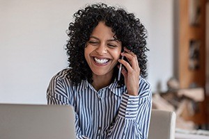 Woman calling to schedule a dental checkups and teeth cleaning visit