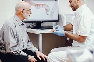 Dentist and patient discussing the dental implant process