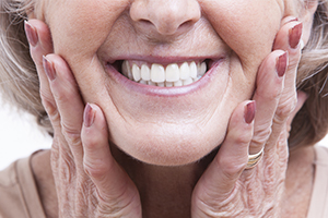 Woman showing off smile after dental implant salvage