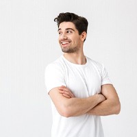 Man smiling confidently after receiving dental implant restorations