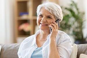 Woman calling to schedule a dental implant consultation
