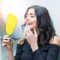 Happy young woman admiring the results of her cosmetic dentistry treatment