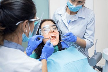 Woman having her tooth filled