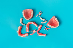 Variety of dentures pictured against blue background