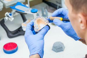 Dental lab technician working on dentures