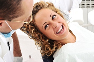 Woman smiling at dentist after oral cancer screening