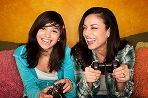 Young woman with braces and her mother laughing together
