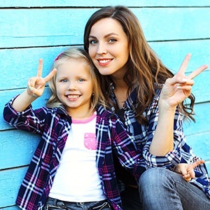 Mother and daughter smiling together after children's dentistry visit