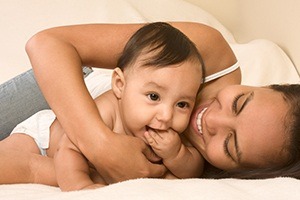 Mother smiling with teething baby