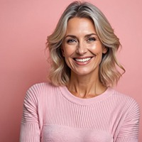 Portrait of smiling, mature woman wearing a pink sweater