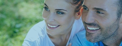 Man and woman with healthy smiles after emergency dentistry