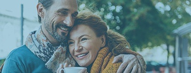 Man and woman smiling after sedation dentistry