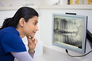 Dental team member looking at digital x-rays