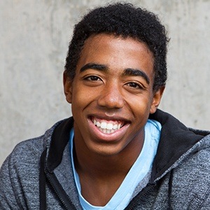 Young man smiling after wisdom tooth extractions