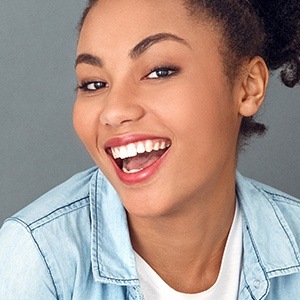 Woman sharing bright smile after zoom in office teeth whitening