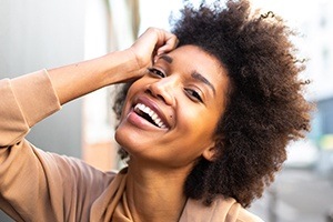 Woman sharing gorgeous smile after zoom in office teeth whitening