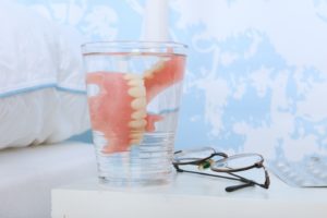 soaking dentures on bedside table