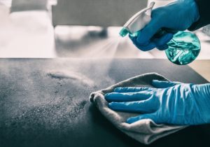 sanitizing countertop as part of dental safety protocol in Bloomfield