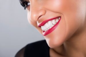 Close-up side view of woman’s bright white smile