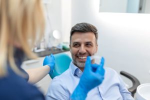 Happy male patient visiting dentist for Invisalign appointment