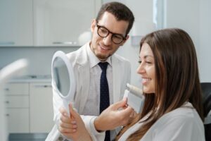 Dental patient admiring her new veneers