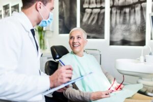 Smiling patient talking to her dentist 
