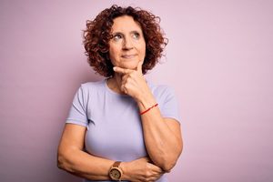 Mature woman wearing thoughtful, curious expression